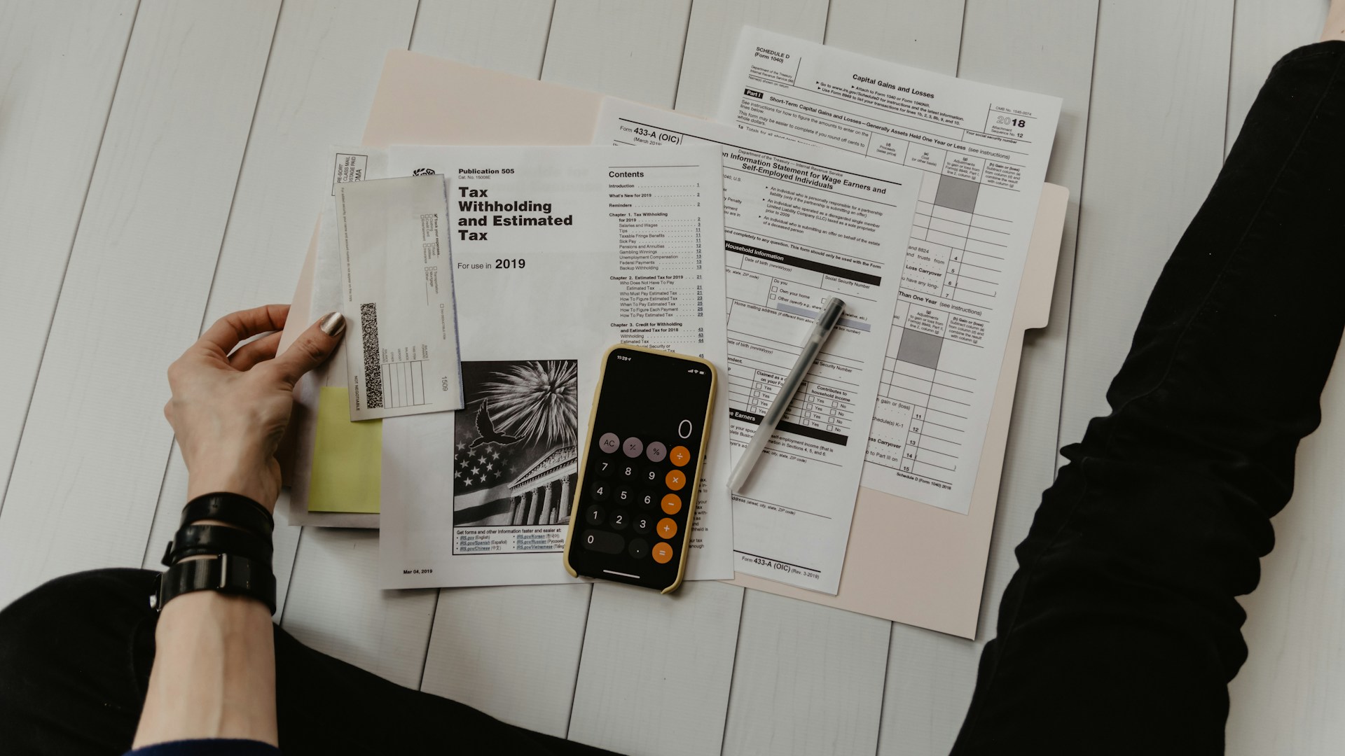 Person managing finances on phone